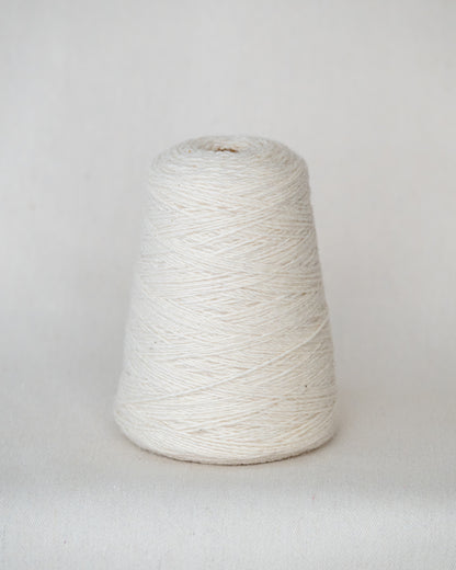 White yarn cone on a light gray background